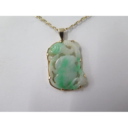 480 - A gilt metal mounted jade pendant on a 14ct yellow gold chain, 48cm long, total weight approx 9 gram... 