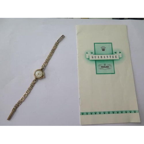 646 - A 9ct yellow gold ladies 1955 Rolex manual wind bracelet wristwatch with original guarantee, 18mm ca... 