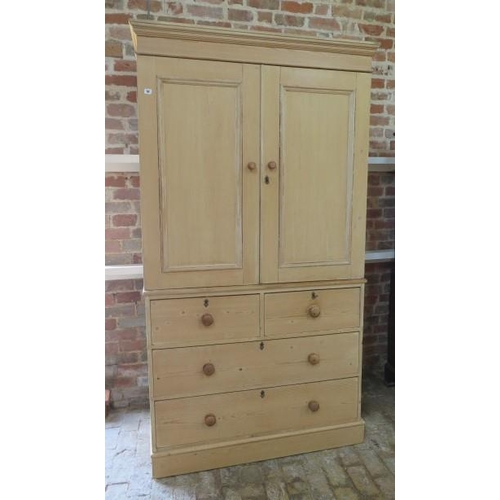 64 - A 19th century stripped pine linen press / cupboard on chest with a 2 door top enclosing two shelves... 