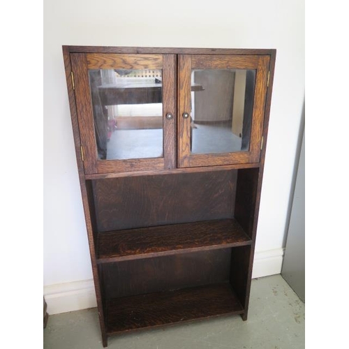 7 - A small oak bookcase with cupboard, 92cm tall x 51cm x 15cm
