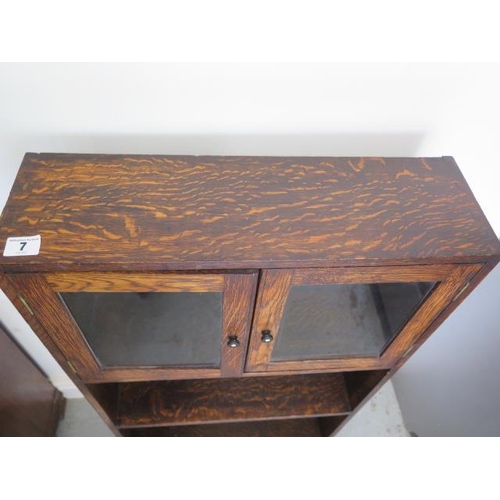 7 - A small oak bookcase with cupboard, 92cm tall x 51cm x 15cm