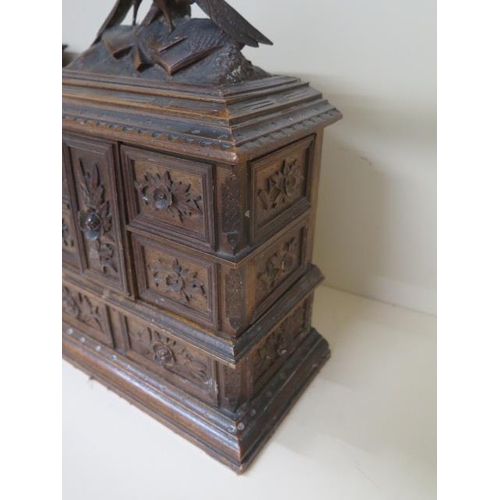 78 - A carved Black Forest jewellery box with rising top and hinged compartments, 34cm tall x 28cm x 14cm... 
