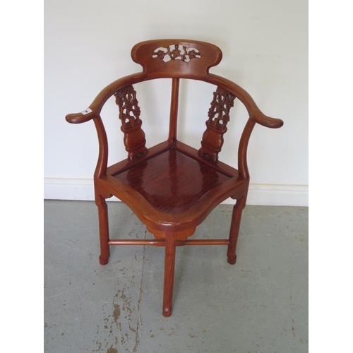 8 - A 20th century Oriental hardwood carved corner comfort chair, 85cm tall x 69cm wide