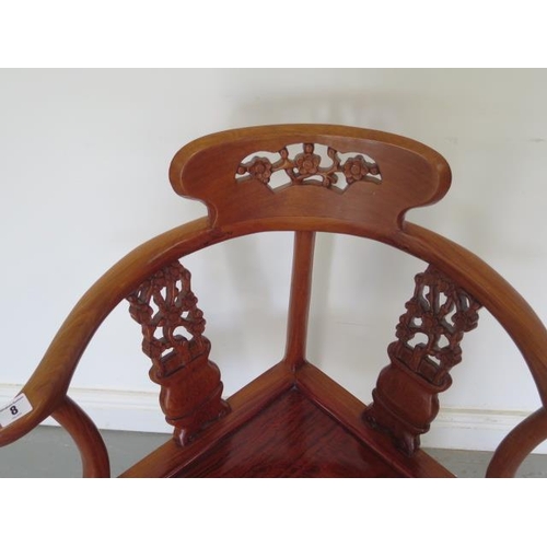 8 - A 20th century Oriental hardwood carved corner comfort chair, 85cm tall x 69cm wide