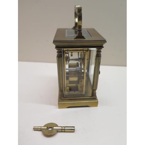 153 - A brass carriage clock, 14cm tall with handle up, in working order