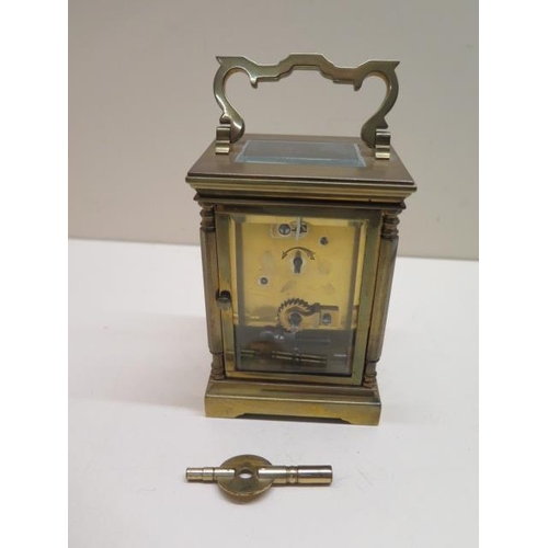 153 - A brass carriage clock, 14cm tall with handle up, in working order