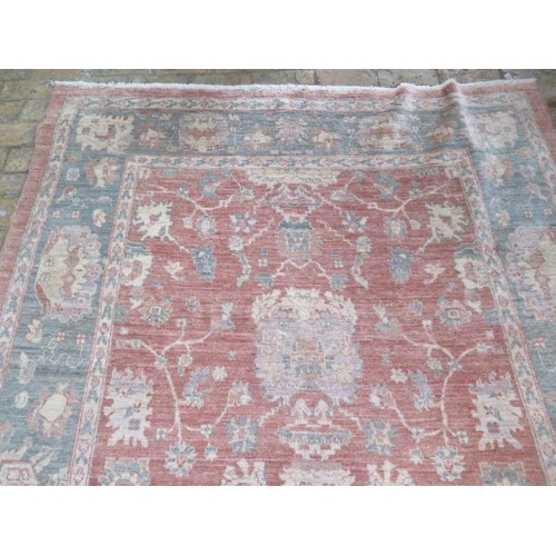 204 - A hand knotted woollen rug, 260cm x 174cm