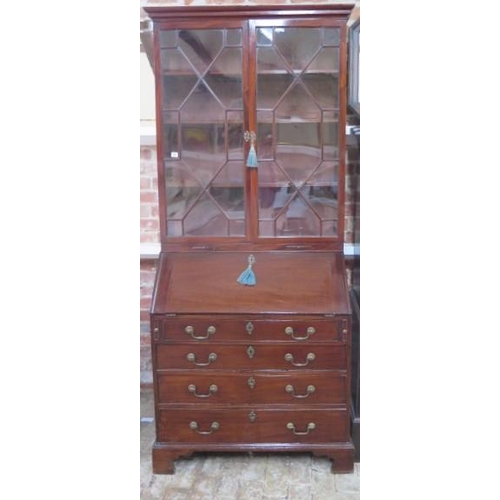 52 - A 19th century mahogany bureau bookcase with an astragel glazed 2 door top having 2 candle slides an... 