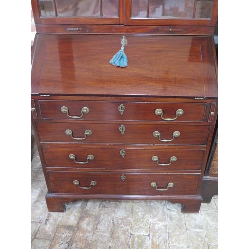 52 - A 19th century mahogany bureau bookcase with an astragel glazed 2 door top having 2 candle slides an... 