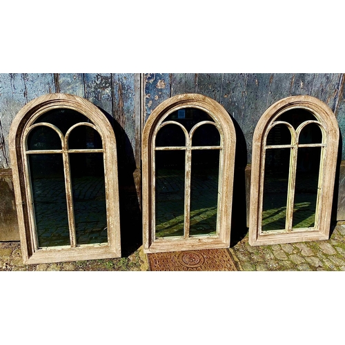 ARCHITECTURAL WALL MIRRORS, a set of three, distressed finis...