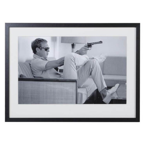 73 - AFTER JOHN DOWNING, STEVE MCQUEEN WITH GUN, 54cm x 74cm, framed and glazed.