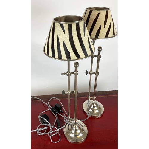 38 - TABLE LAMPS, a pair, telescopic chrome column with zebra pattern painted hide shades, fully extendab... 