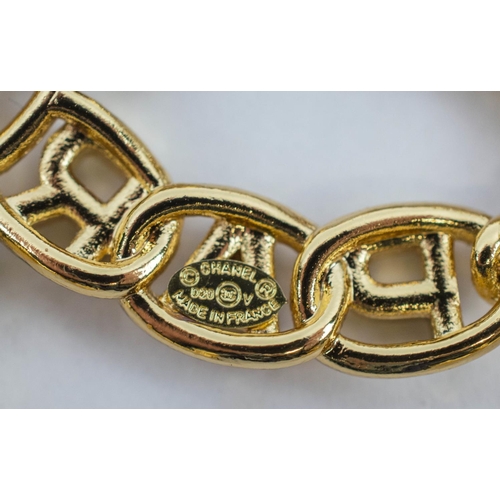 100 - CHANEL BROOCH, gilt metal, in the form of the Chanel logo, bearing letters reading Chanel Paris, ins... 