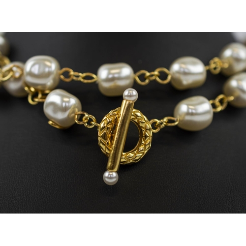 104 - CHANEL NECKLACES, a pair, faux pearl and gold tone, stamped, each with hook and loop clasp can be wo... 