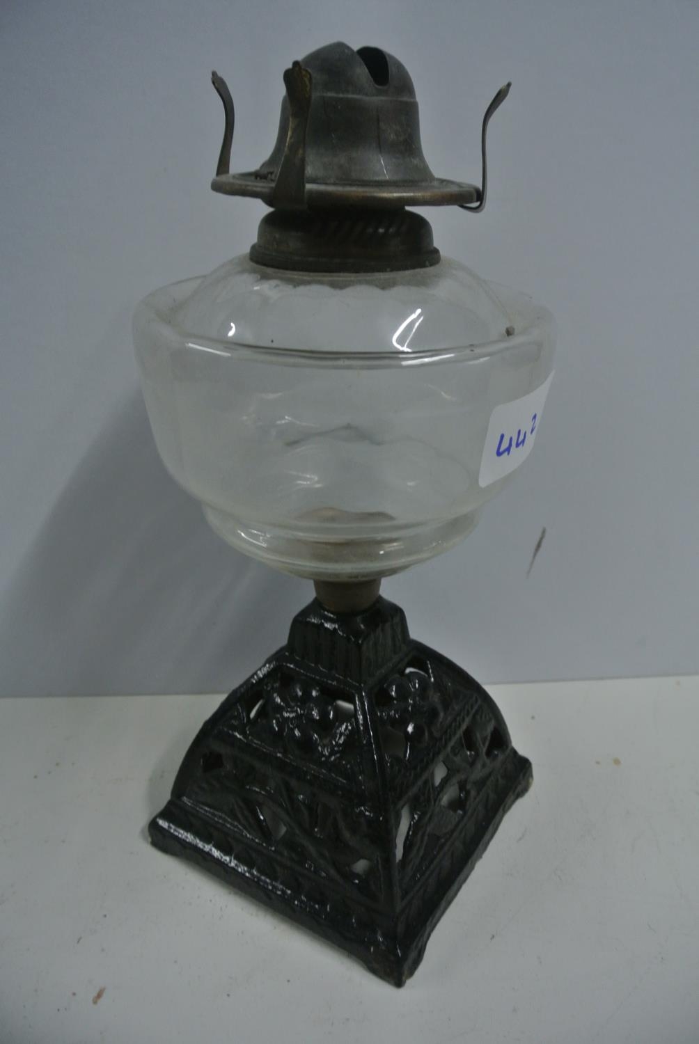 A vintage oil lamp reservoir on cast iron base, 'Young's Comet Burner'
