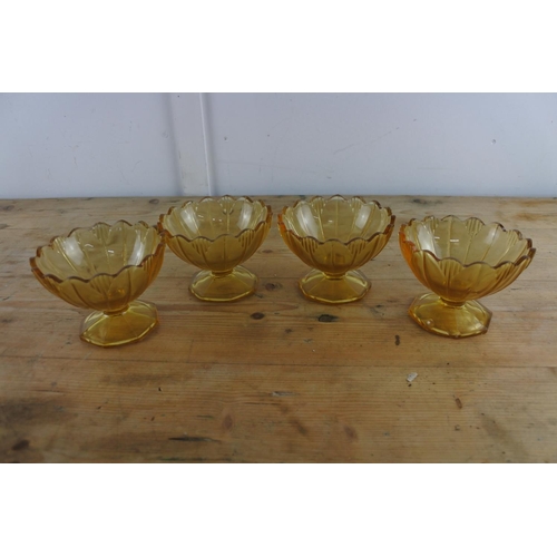 205 - Four amber glass sundae dishes.