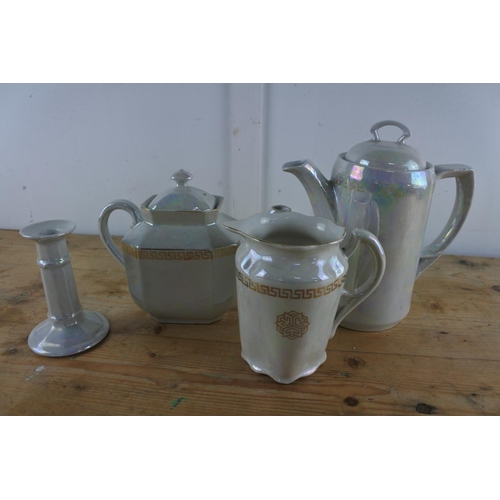 206 - A three piece ceramic tea/coffee set and a matching candlestick.