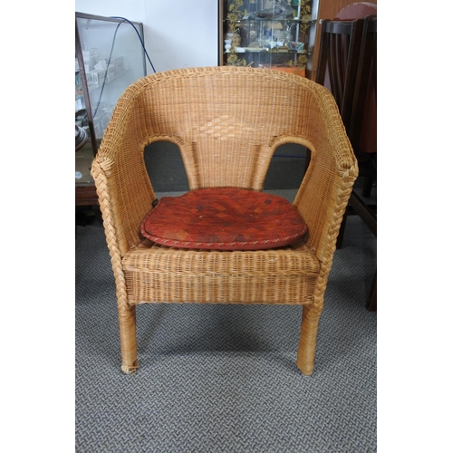 226 - A vintage wicker armchair.