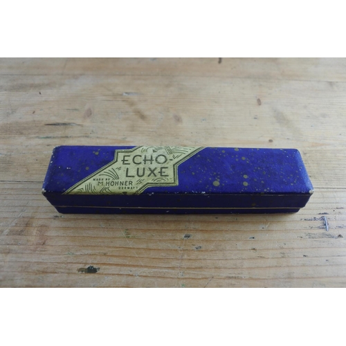 242 - A vintage Horner Echo-Luxe harmonica in the key of C with pink and blue enamel plates in perfect tun... 