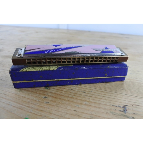 242 - A vintage Horner Echo-Luxe harmonica in the key of C with pink and blue enamel plates in perfect tun... 