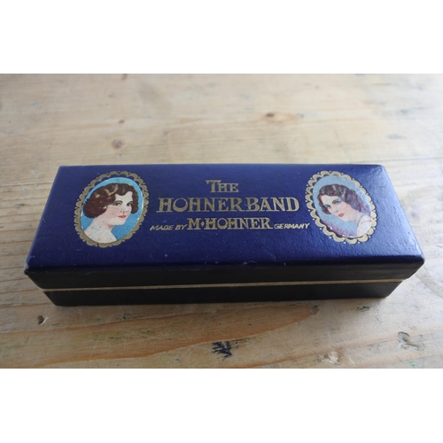 247 - A vintage Horner 'The Horner Band' curved harmonica in they key of C in perfect tune and in its orig... 