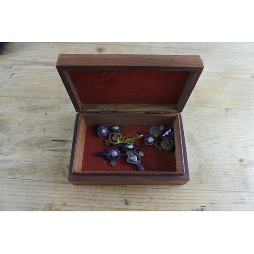 271 - A wooden and brass jewellery box and a collection of Royal British Legion badges.