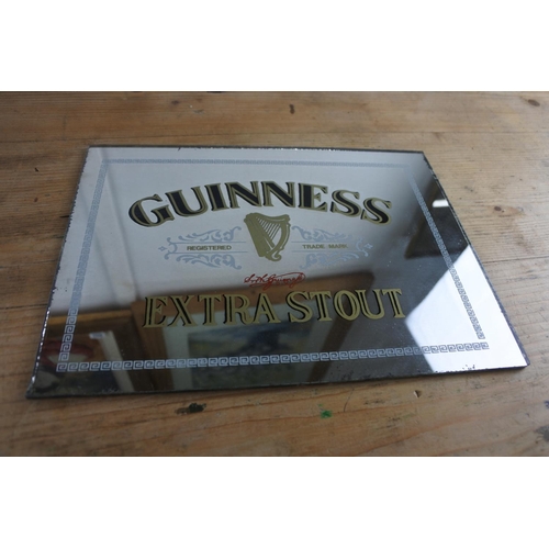 274 - A Guinness Extra Stout advertising mirror. (Measuring 24x18cm)