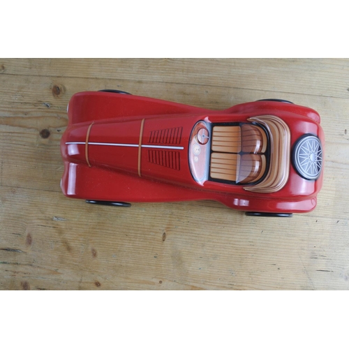 292 - A tin confectionery or biscuit tin in the shape of a racing car.