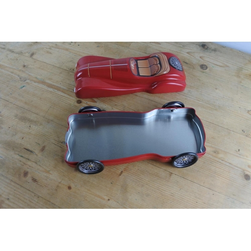 292 - A tin confectionery or biscuit tin in the shape of a racing car.