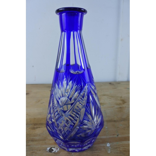 311 - A late 19th century/early 20th century tapering clear glass decanter cased in dark blue with cut inw... 