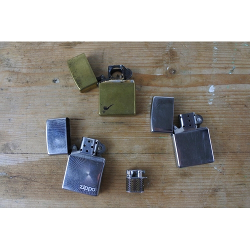 323 - Three vintage Zippo lighters and another.