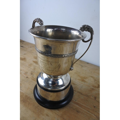 324 - A large two handled silver plated presentation cup 'The Carol Barber Memorial Cup'.