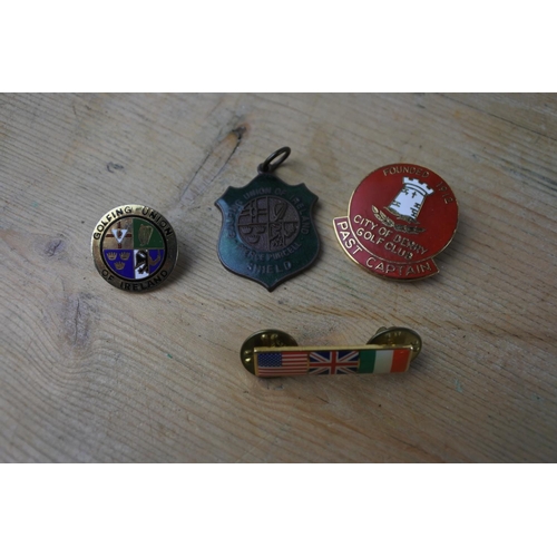327 - A Golfing Union of Ireland pendant and three other badges.