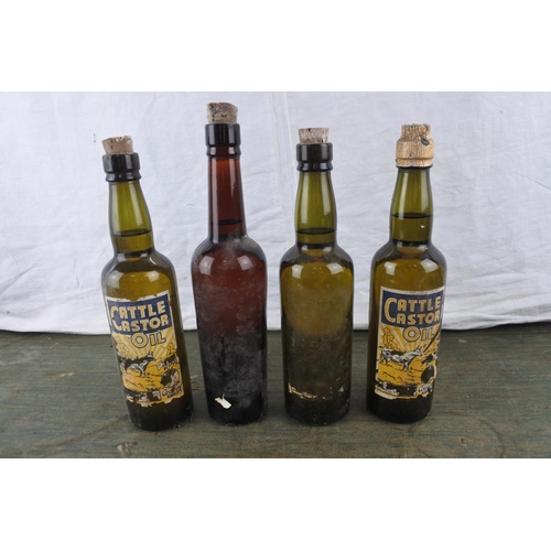 10 - Four vintage 'Cattle Castor Oil' bottles. (some with contents)