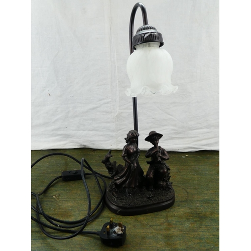 105 - A decorative table lamp and shade.