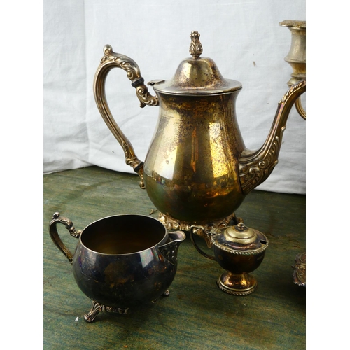 113 - A four piece silver plated tea service and more.