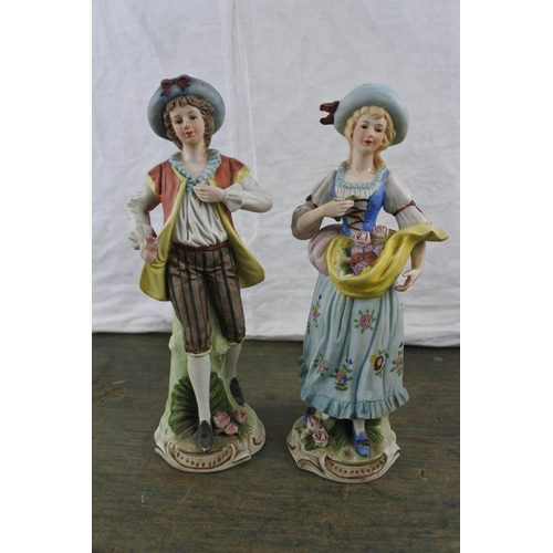 14 - A pair of early twentieth century continental bisque porcelain figurines.