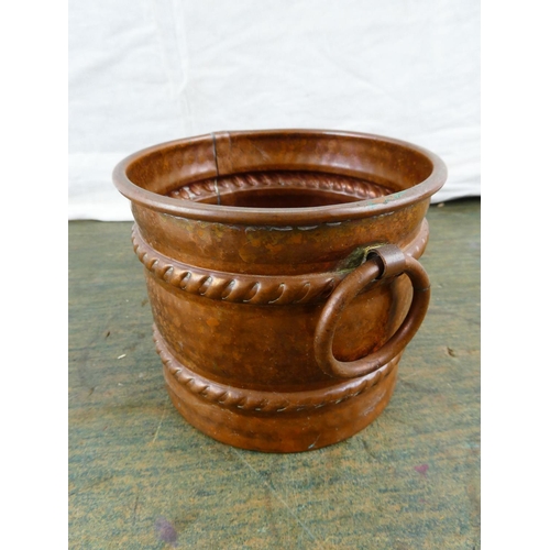 142 - A copper two handled plant pot.
