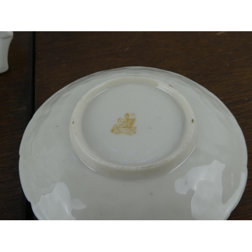155 - A Belleek mantle clock and plate.