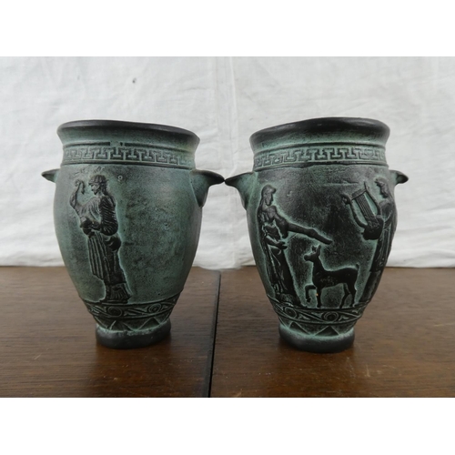 160 - A pair of small Roman style vases.