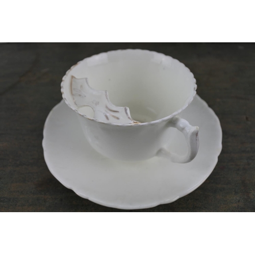 17 - An antique mustache cup and saucer.