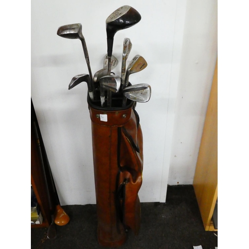 50 - A vintage golf bag and clubs.