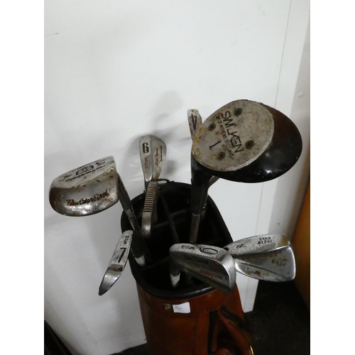 50 - A vintage golf bag and clubs.