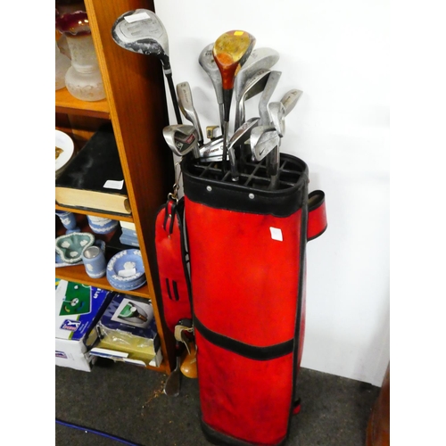 51 - A vintage golf bag and clubs.