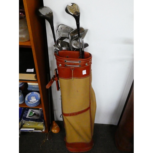 52 - A vintage golf bag and clubs.