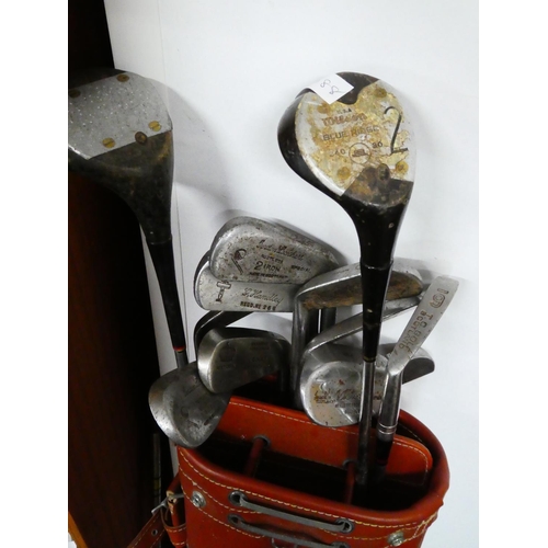 52 - A vintage golf bag and clubs.