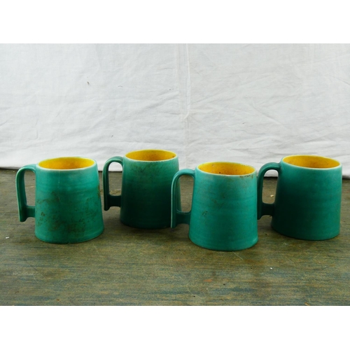 82 - A stunning set of four antique Bretby pottery mugs.