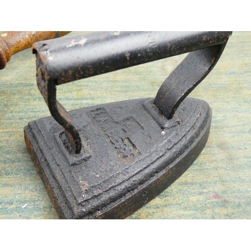 86 - An antique cast iron iron and an antique style trivet.