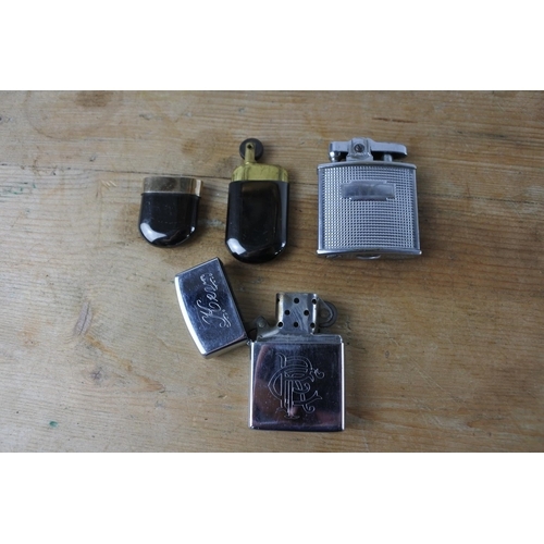 310 - Three vintage lighters.