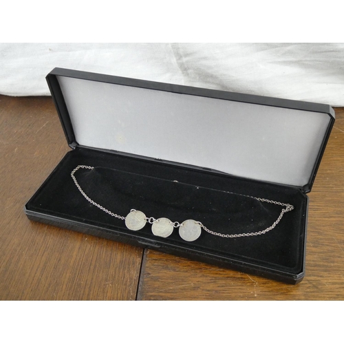 506 - A silver 3 pence necklace.